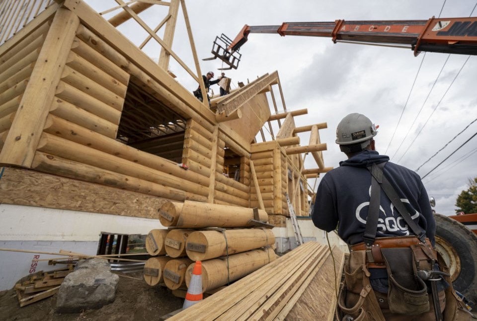 Westwind Digital team member in a tool belt at a North Shore timber frame job site